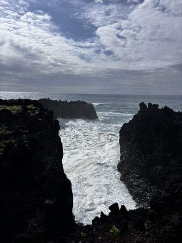 Wild Atlantic ocean crashing against the volcanic Azores coastline — powerful, dramatic, and completely indifferent to any plans