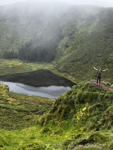 Anca on a mountain in Sao Miguel, genuinely happy despite (or because of) the conditions