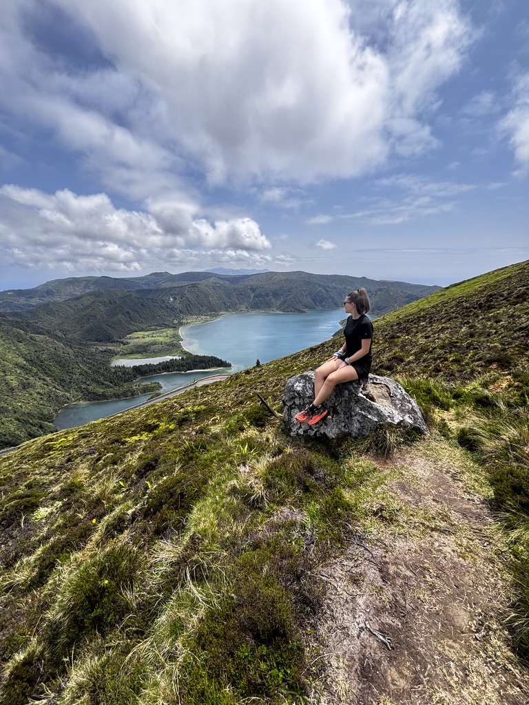 Anca sitting quietly in the Azores landscape — small, still, part of something much larger