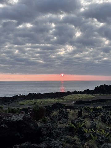 Sunset over Sao Miguel, Azores — the sky going gold and orange above the volcanic island