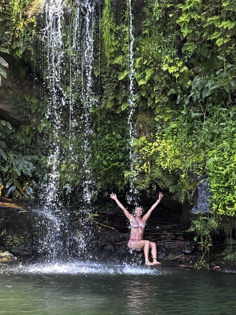 Swimming towards a waterfall in Sao Miguel — the water cold, the pull of the falls irresistible