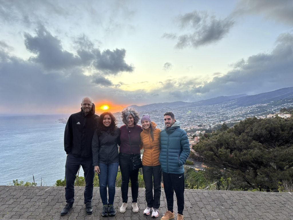 Group of five friends watching sunset above Funchal, Madeira