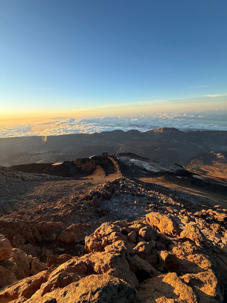 The vast El Teide caldera — dark volcanic rock, summit cone, deep blue sky