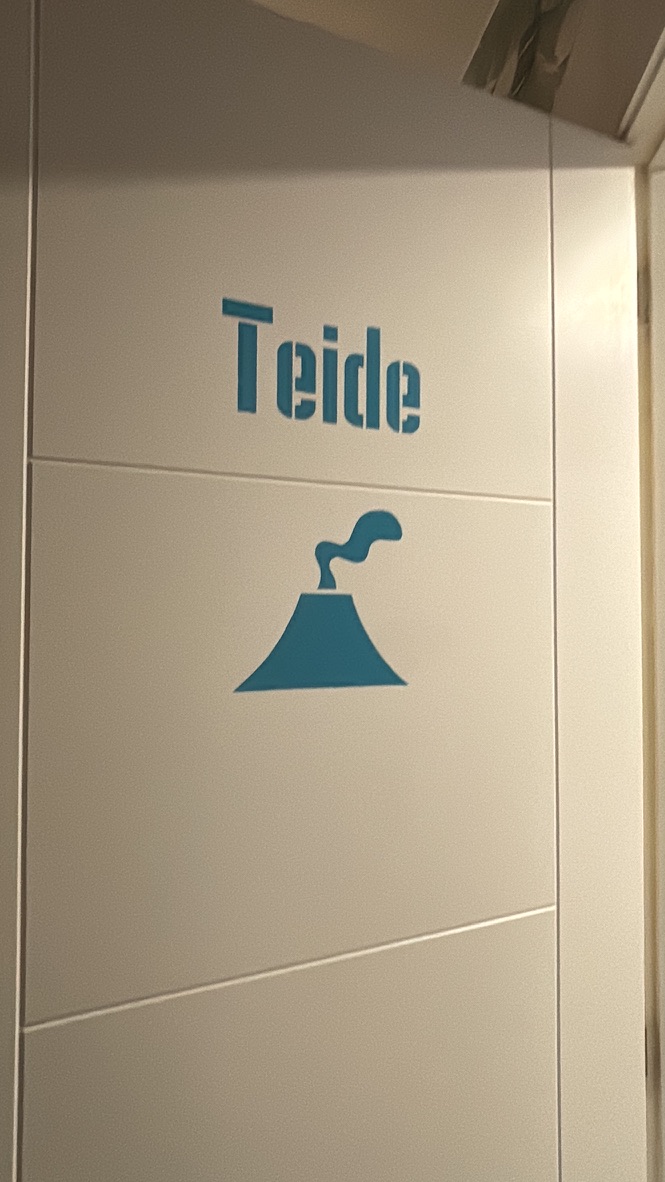 The hostel room door with a sign reading 'El Teide' — the room Anca checked into immediately after finishing the El Teide hike