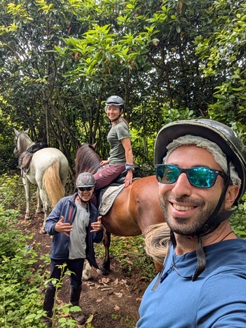Group on horseback in Sao Miguel — riders in a line through the green Azorean countryside