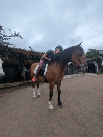 Anca kissing her horse goodbye at the end of the ride in Sao Miguel — a real thank you