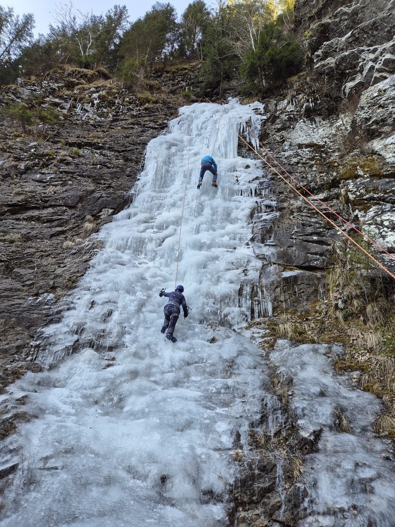 Two climbers ascending a frozen waterfall near Cluj