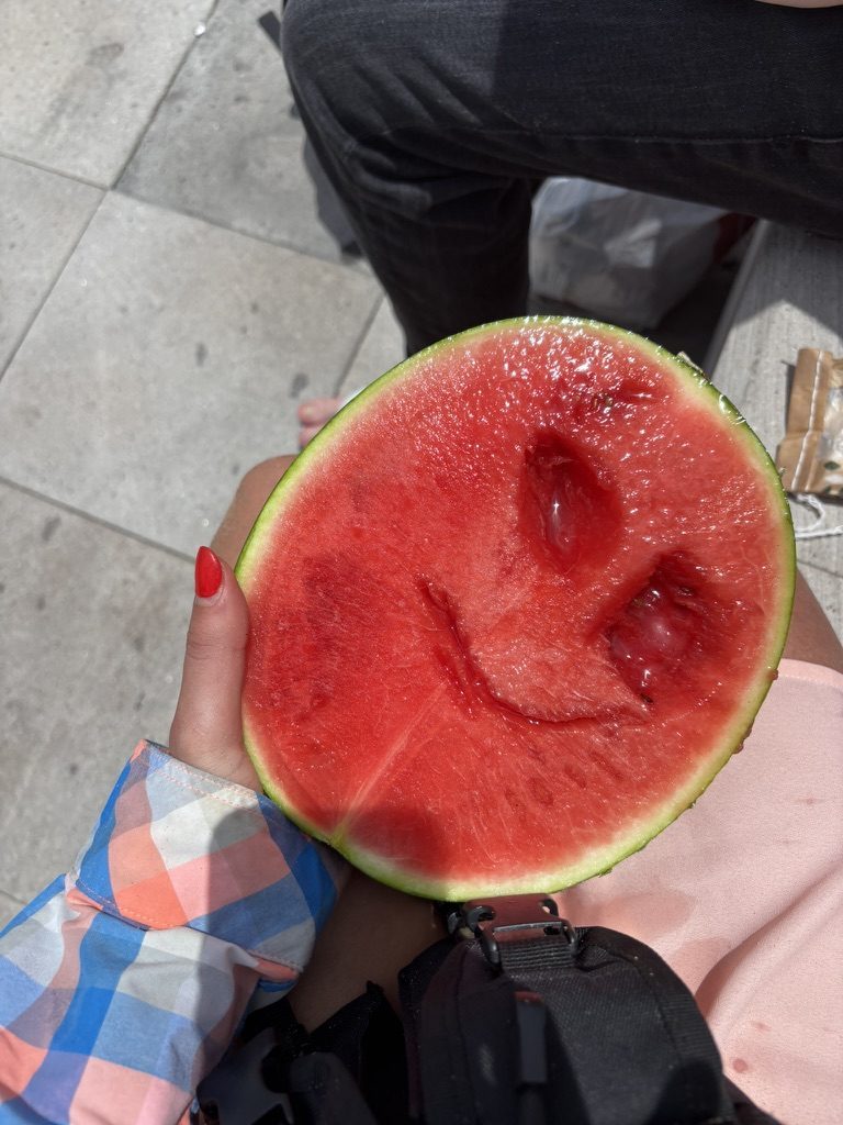 Close-up of half a watermelon with the exposed flesh forming a natural smiley face pattern
