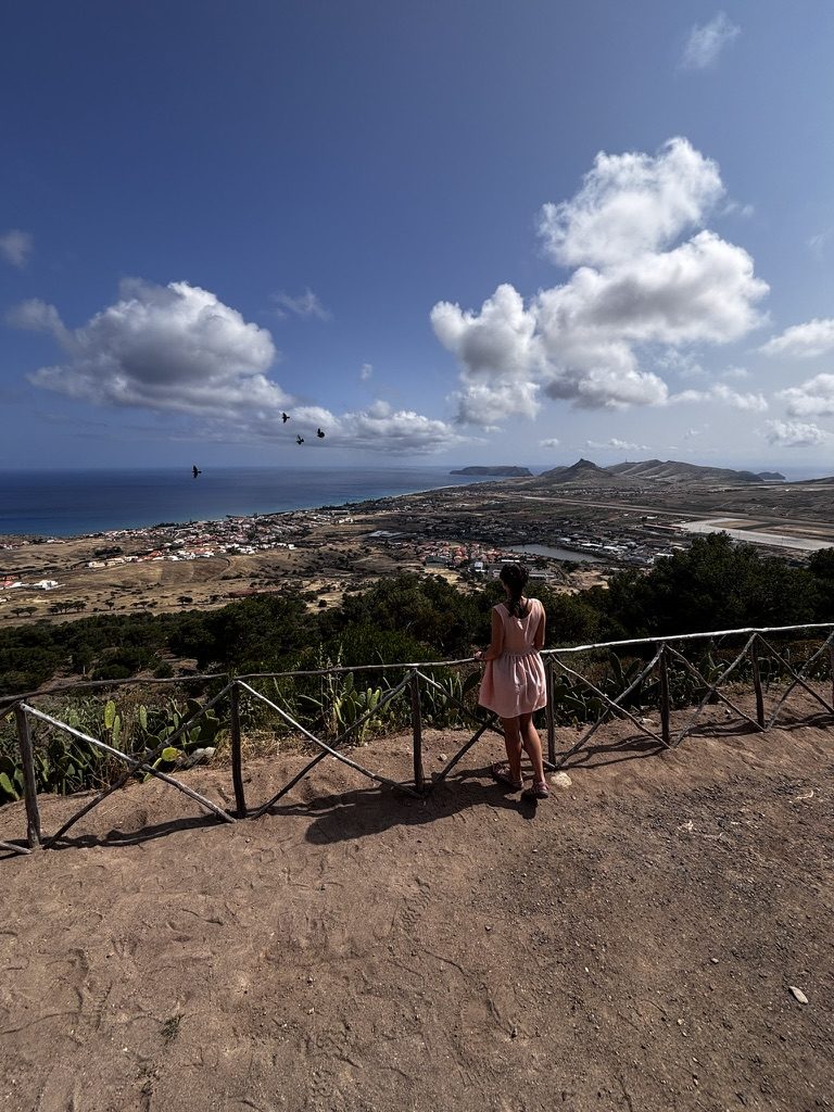 Porto Santo's long golden beach with dramatic storm clouds and turquoise water