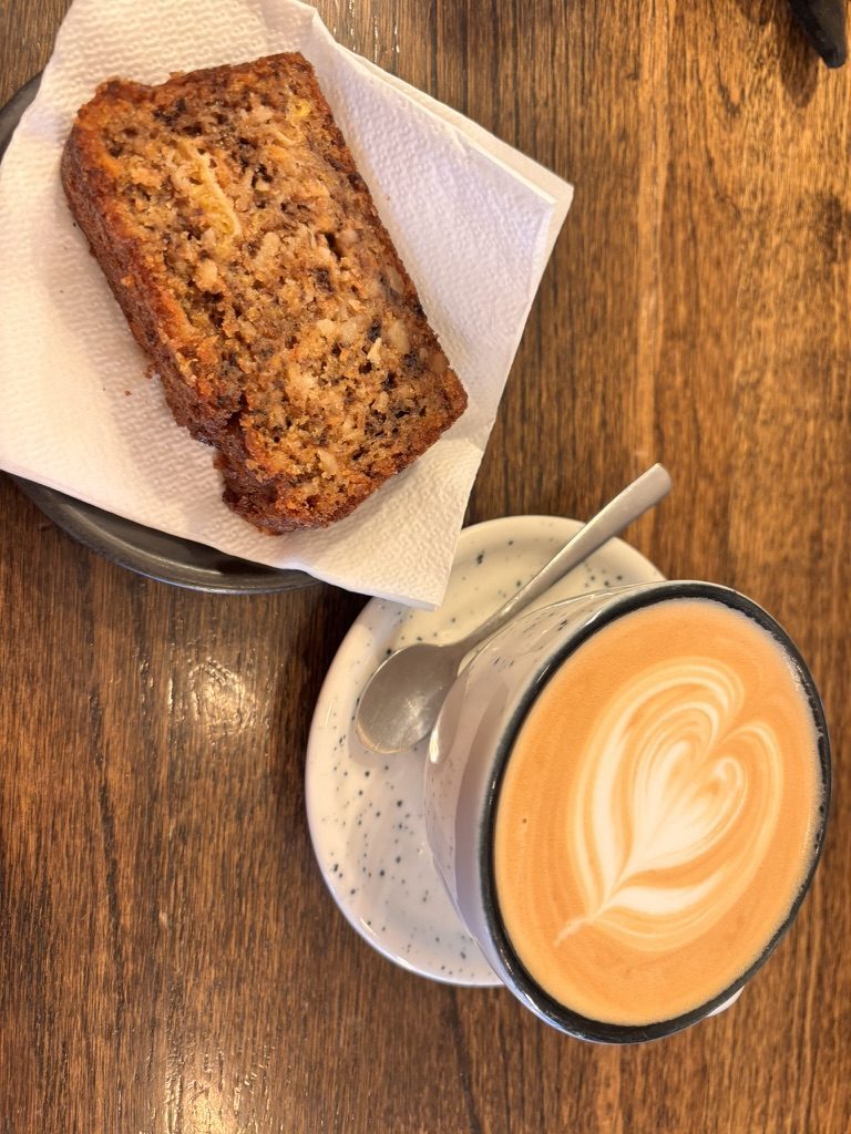 Thick slice of homemade banana bread on a plate at Delight Café Sibiu, afternoon light