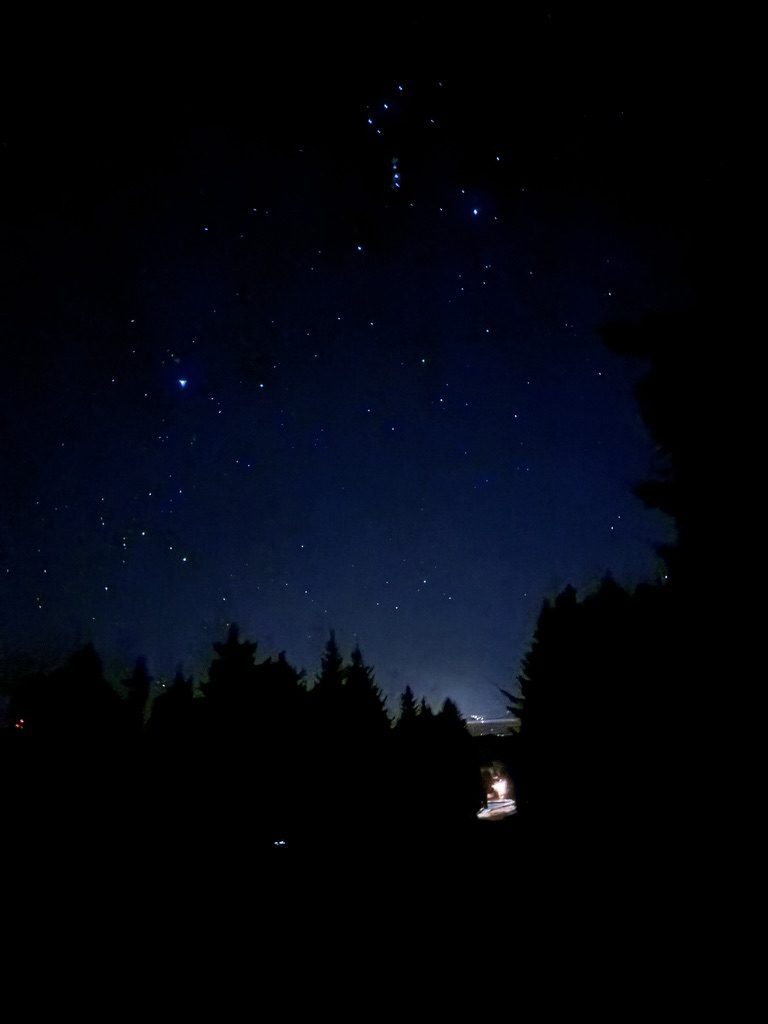 Night at the camp after the fire show, a head-torch glowing in the dark as we hike up to watch the stars