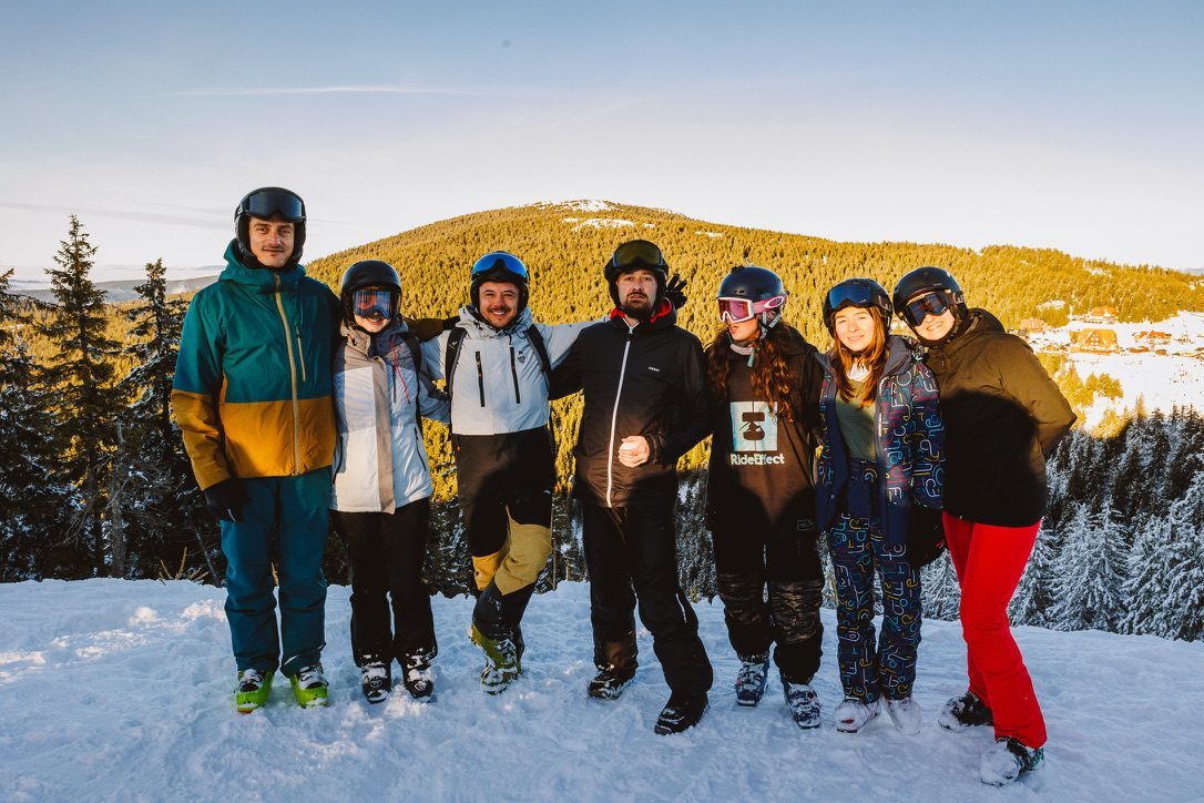 Group of skiers at golden hour on a Romanian ski slope
