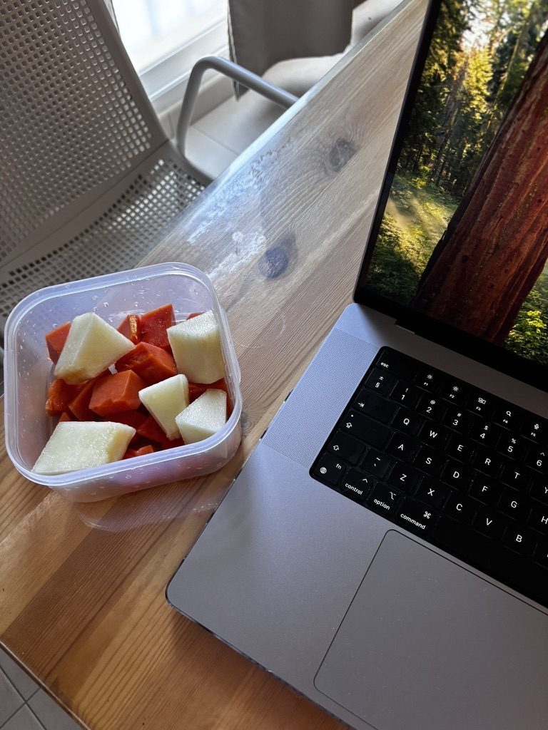 Laptop, coffee and something sweet on a table with Tenerife sunshine, the ideal remote work setup