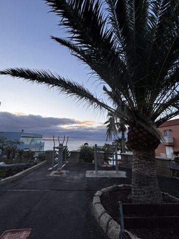 Outdoor gym equipment on the Tenerife seafront, Anca mid-workout, sea behind her