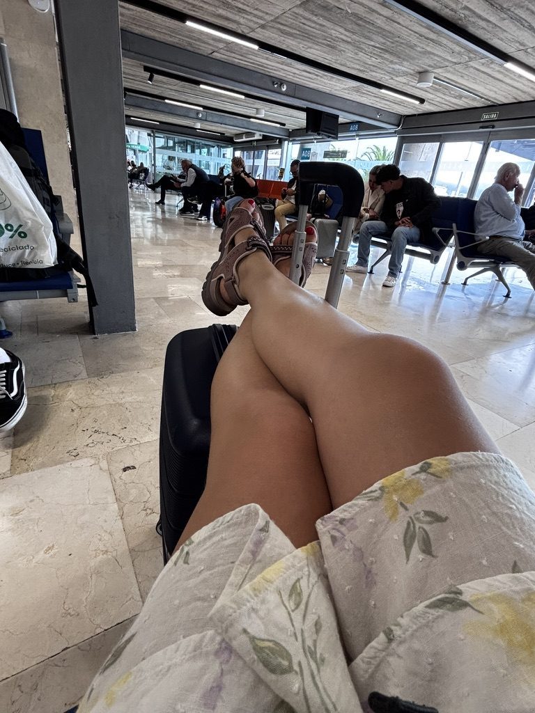 Anca at the departure point — bag packed, looking forward, the end of the Tenerife chapter