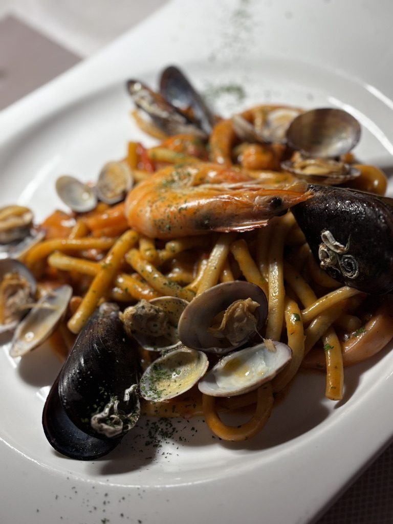 A proper pre-race meal laid out — pasta, bread, everything a cyclist eats before five hours on a bike