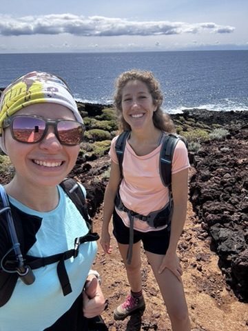 Anca and her Italian hiking buddy on the coastal lava trail in Tenerife, ocean behind them