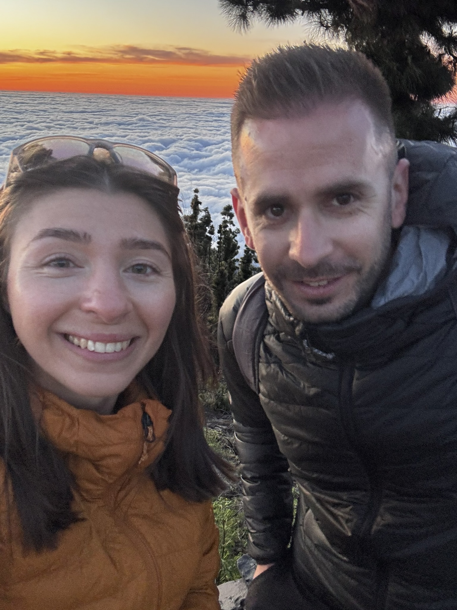 Anca with her French hiking companion at a Tenerife viewpoint — golden hour light, two people having the best time